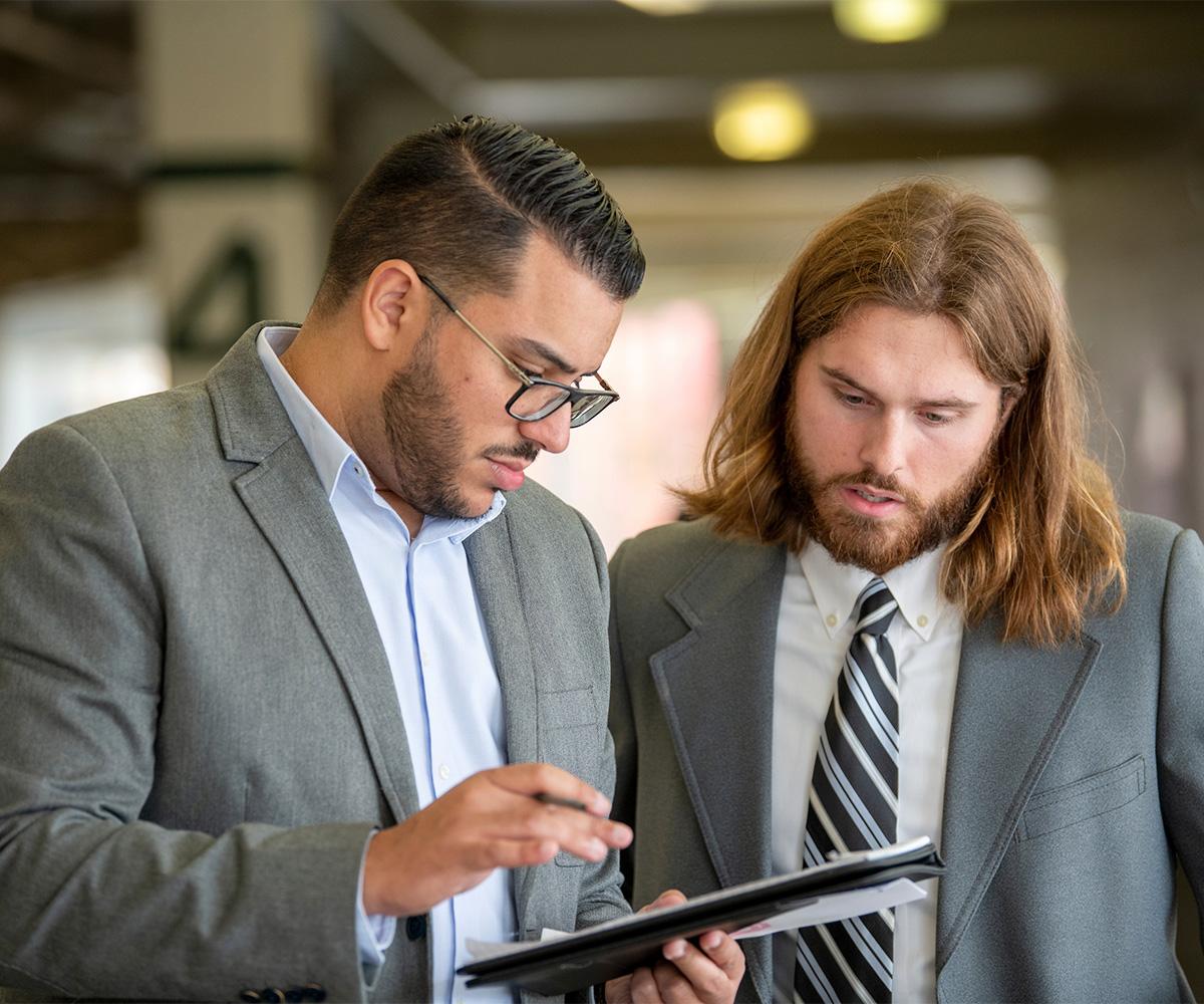 Two people review a document together.