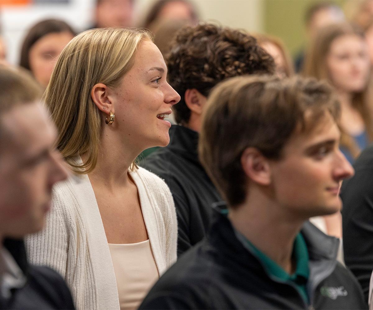 Students listen during a conference.