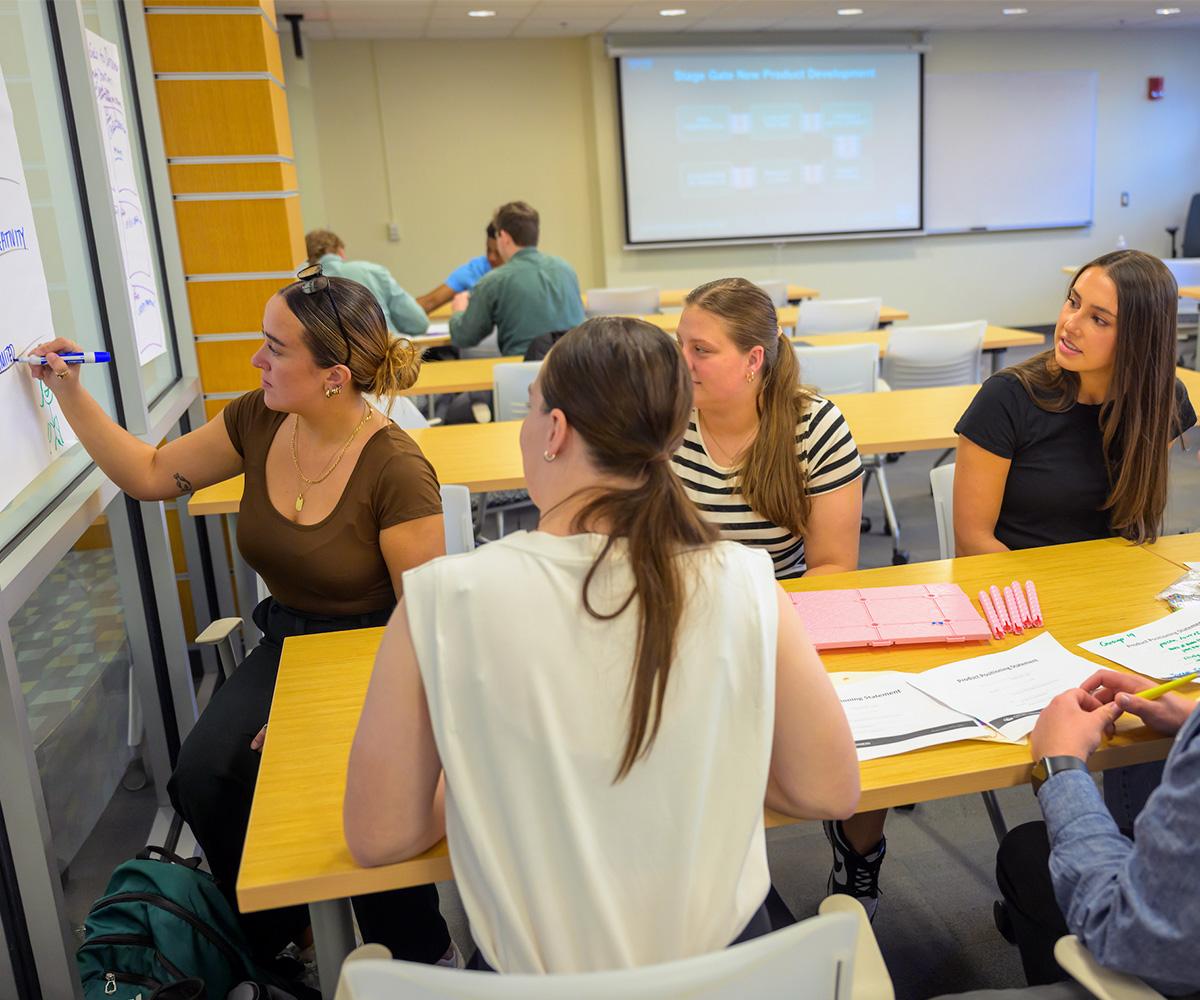 Students work together on a brainstorming session in class.