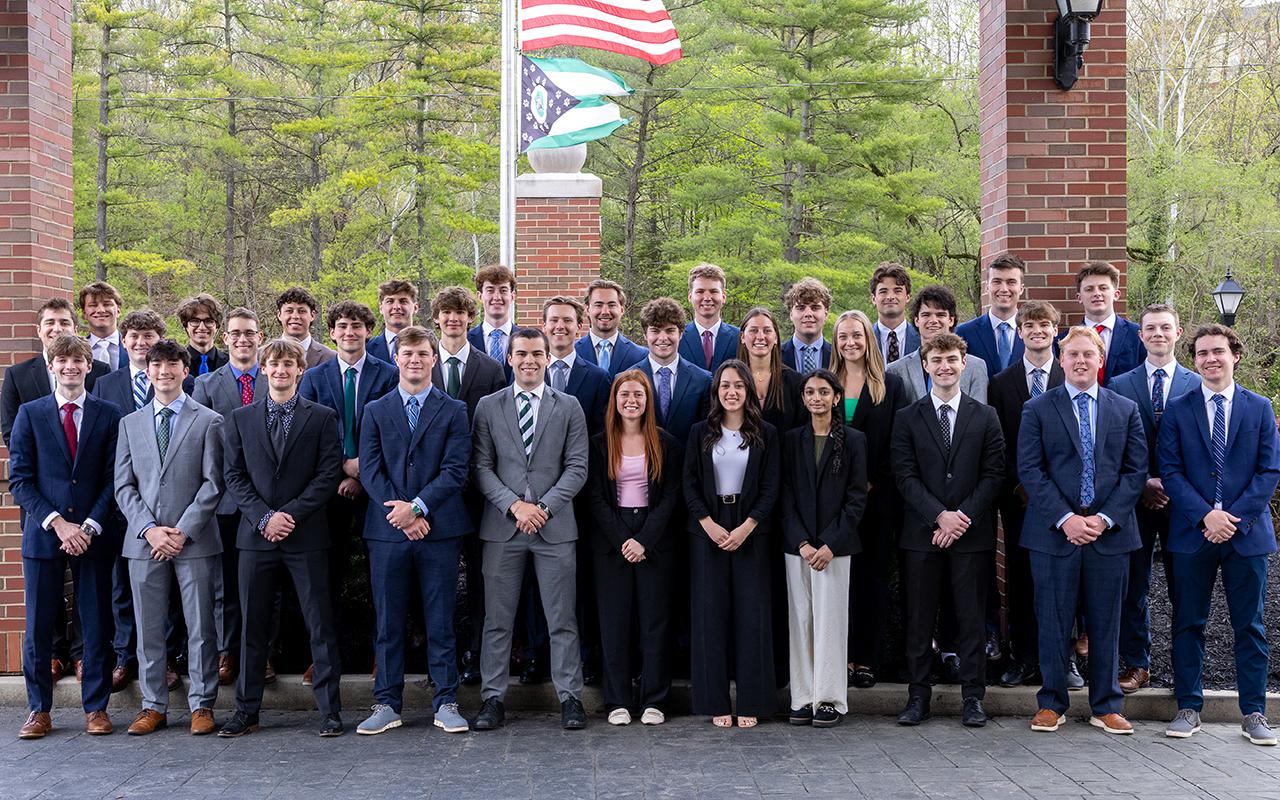 Large group of students dressed in business casual posing for a group photo