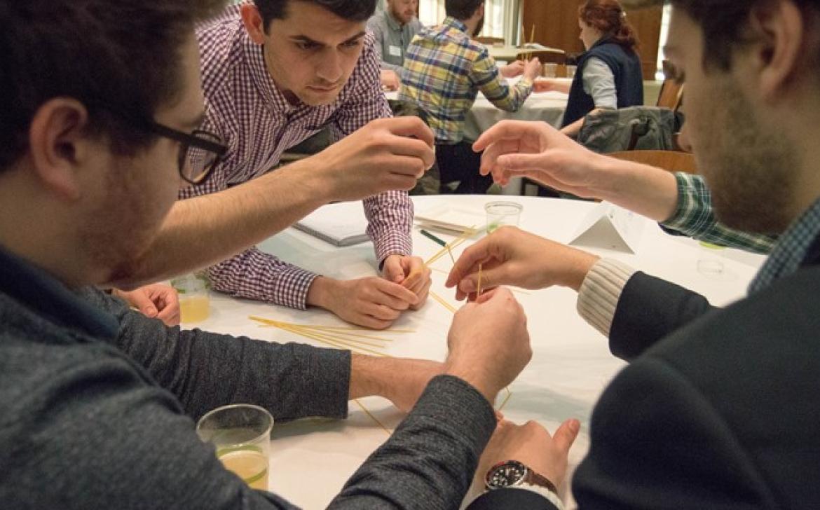 Business students work on a group activity at a table together