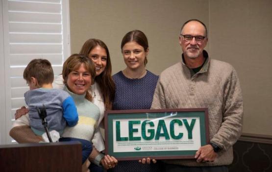 Rachel Isreal and Natalie Sova (Seniors) presenting Tim and Tammy with a Lifetime Legacy Award