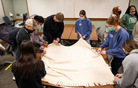 Members of Emerging Leaders and Wandell Fellows collaborate to make blankets for Timothy House