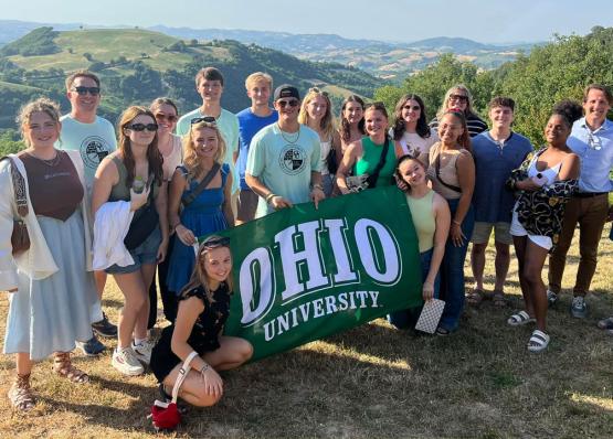 GCP Group Photo holding Ohio Flag in Italy