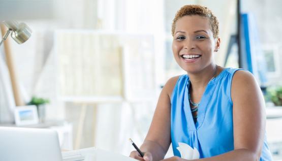 Woman smiling and writing notes