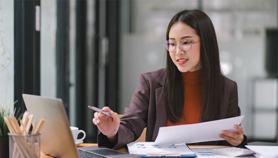 Business woman pointing at laptop