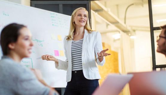 Female Marketing Director discussing strategy with team members.