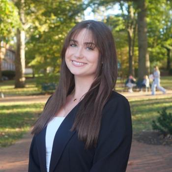 student posing on ohio university green