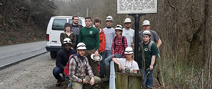 Geology students get their serious caver faces on before crawling through the center of the Flynn Creek impact crater.