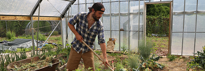 A food intern works at the OHIO Student Farm.
