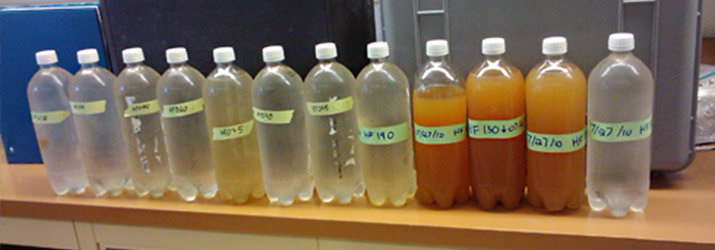 From right: Water collected from the headwaters above the doser (far right). The orange water is from the sacrifice zone, followed by clear water 11 to 12 miles downstream.