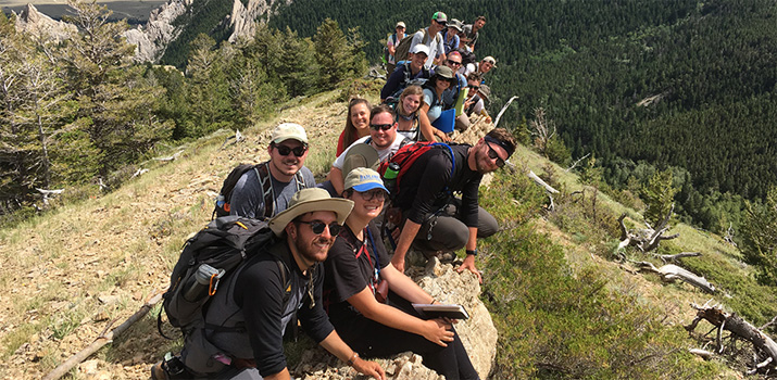 Ohio University geological sciences students pose for a photo atop a mountain.