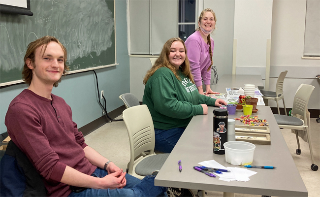 Three Plant Biology Club officers sitting at table