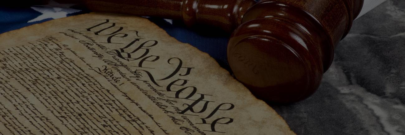 The U.S. Constitution, a gavel, and an American flag 