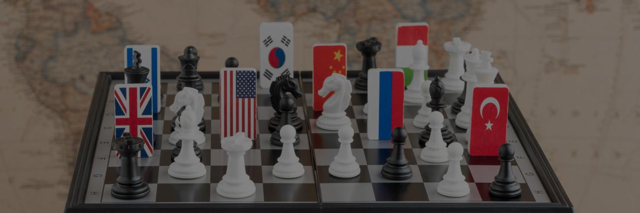 A chess board with international flags atop a world map