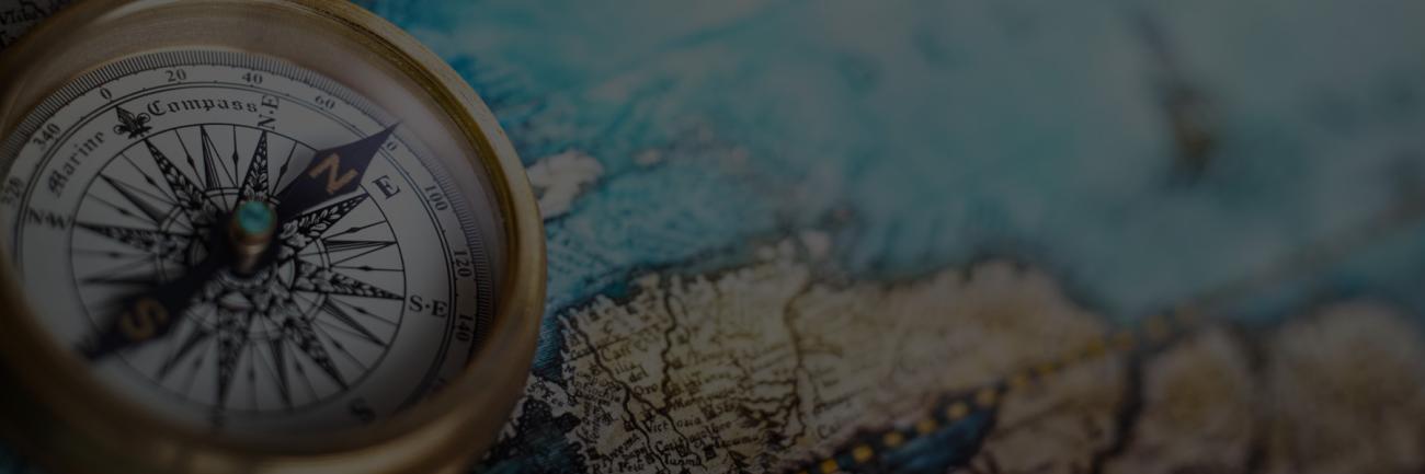 Magnetic compass atop a world map