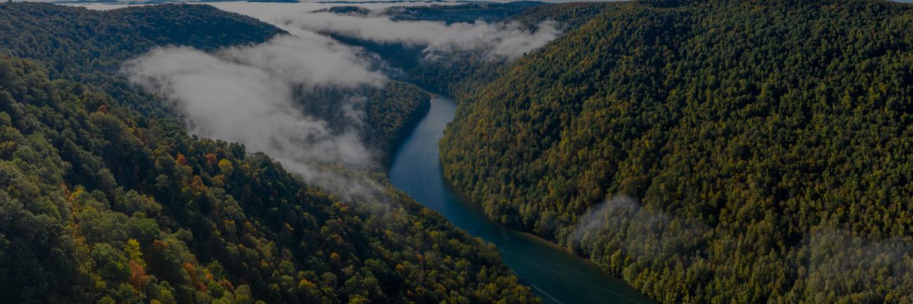 Aerial drone image of the Cheat River flowing through narrow wooded gorge in the autumn towards Cheat Lake near Morgantown, WV