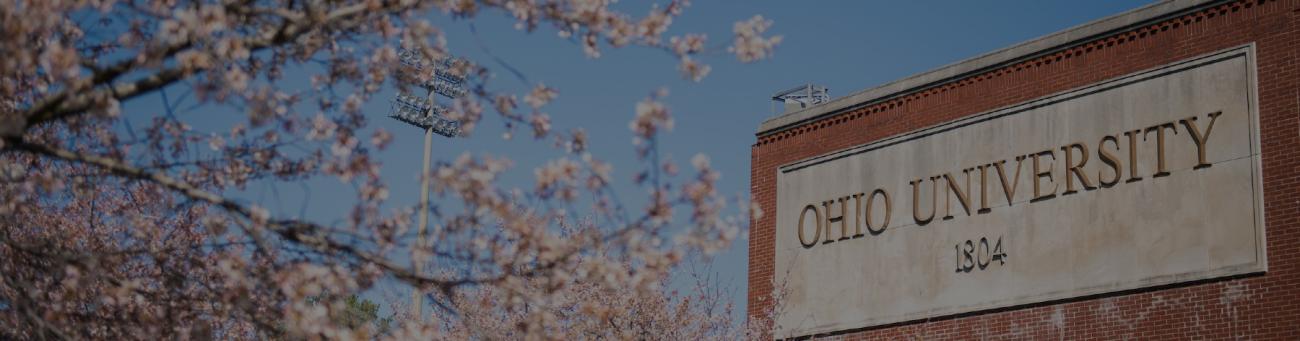 Cherry blossoms blooming in front of Ohio University sign