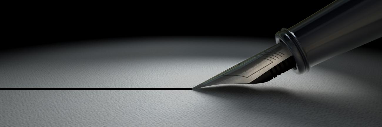 An ink pen making a line across paper