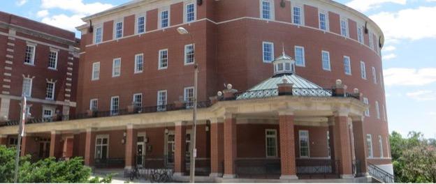 Outside of Bentley hall, showing it's curved shape and covered small atrium with pillars