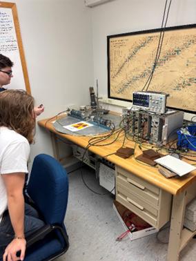 John Edwards and lab partner working on calibrating the two smaller sodium iodide detectors.