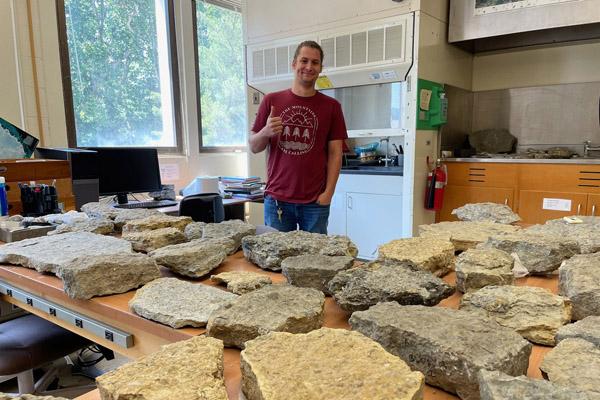 Ian Forstyhe with fossils collected in the field back in the lab in Clippiner