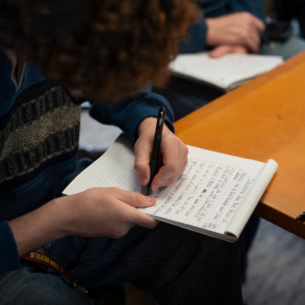 Student takes notes at Pre-Lay Day