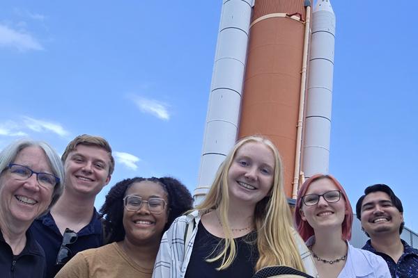 The Mission 21 team in front of a rocket.