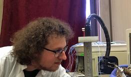 Brian Hivick, in white lab coat in lab