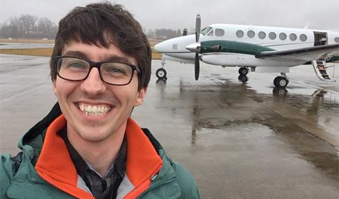 Zachary Meisel, portrait with OHIO airplane in background