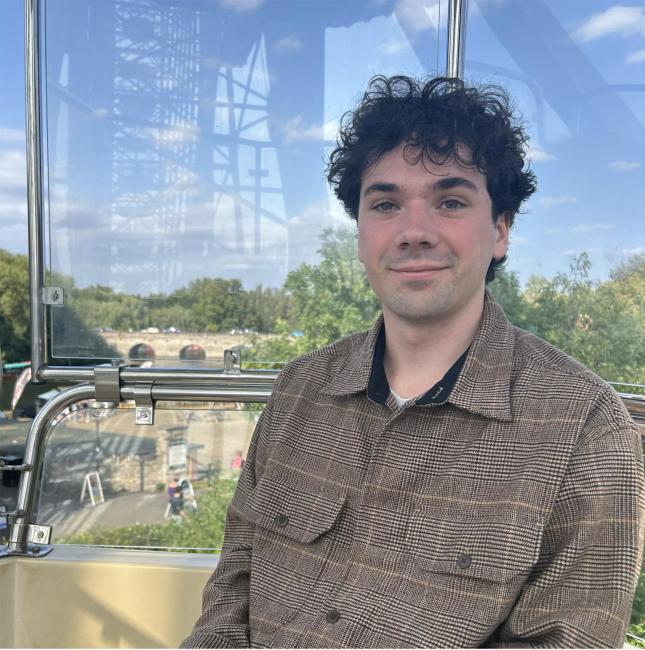 A photo of Max Murtough riding in a gondola.