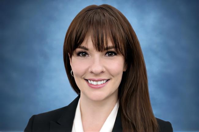 A headshot of Tiffany Sheets, smiling and wearing business clothes.