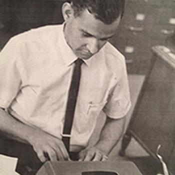 Alvin Adams, working at typewriter