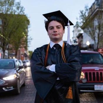 Matt Geiger in his graduation regalia on Court Street in Athens Ohio
