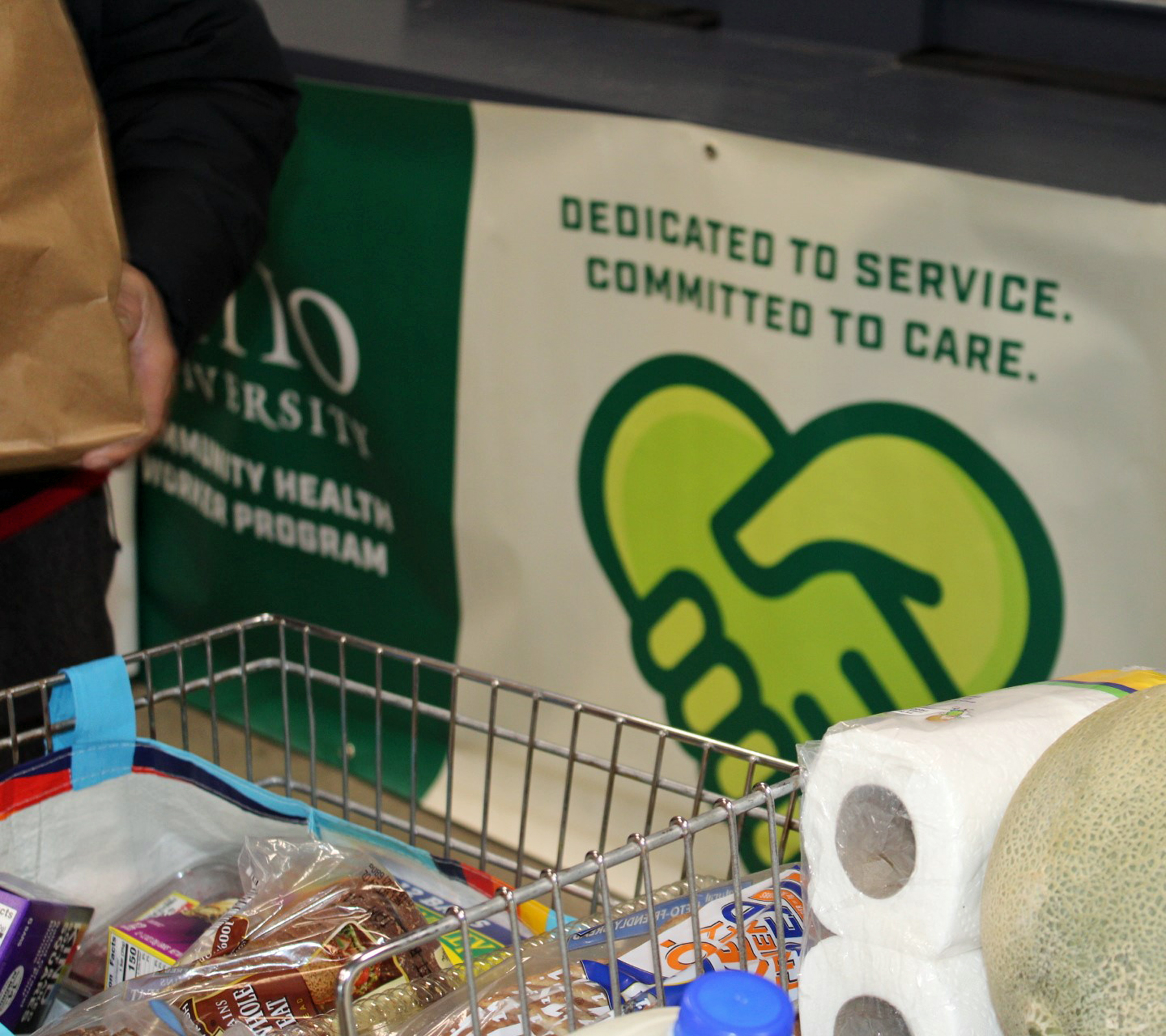Banner with Committed to Service  & Committed to Care, along with grocery cart