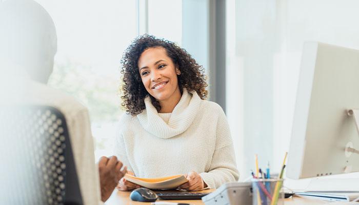Human resources manager at desk with employee candidate