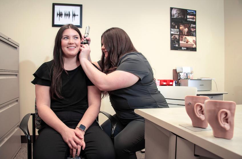A Hearing Speech & Language Pathology student gives a patient an ear examination