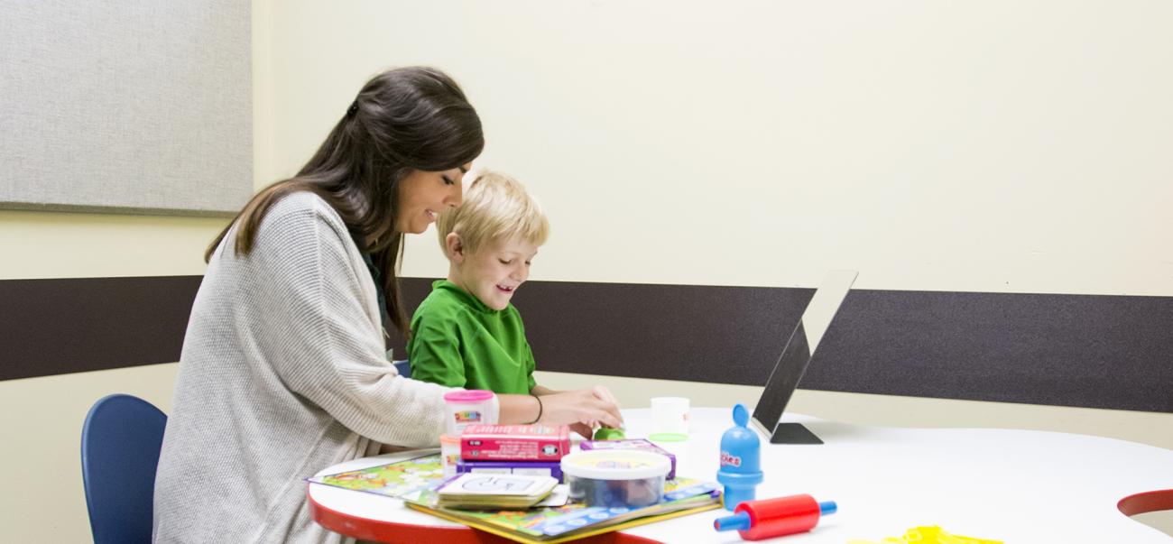 Communication Sciences Student working with a kid