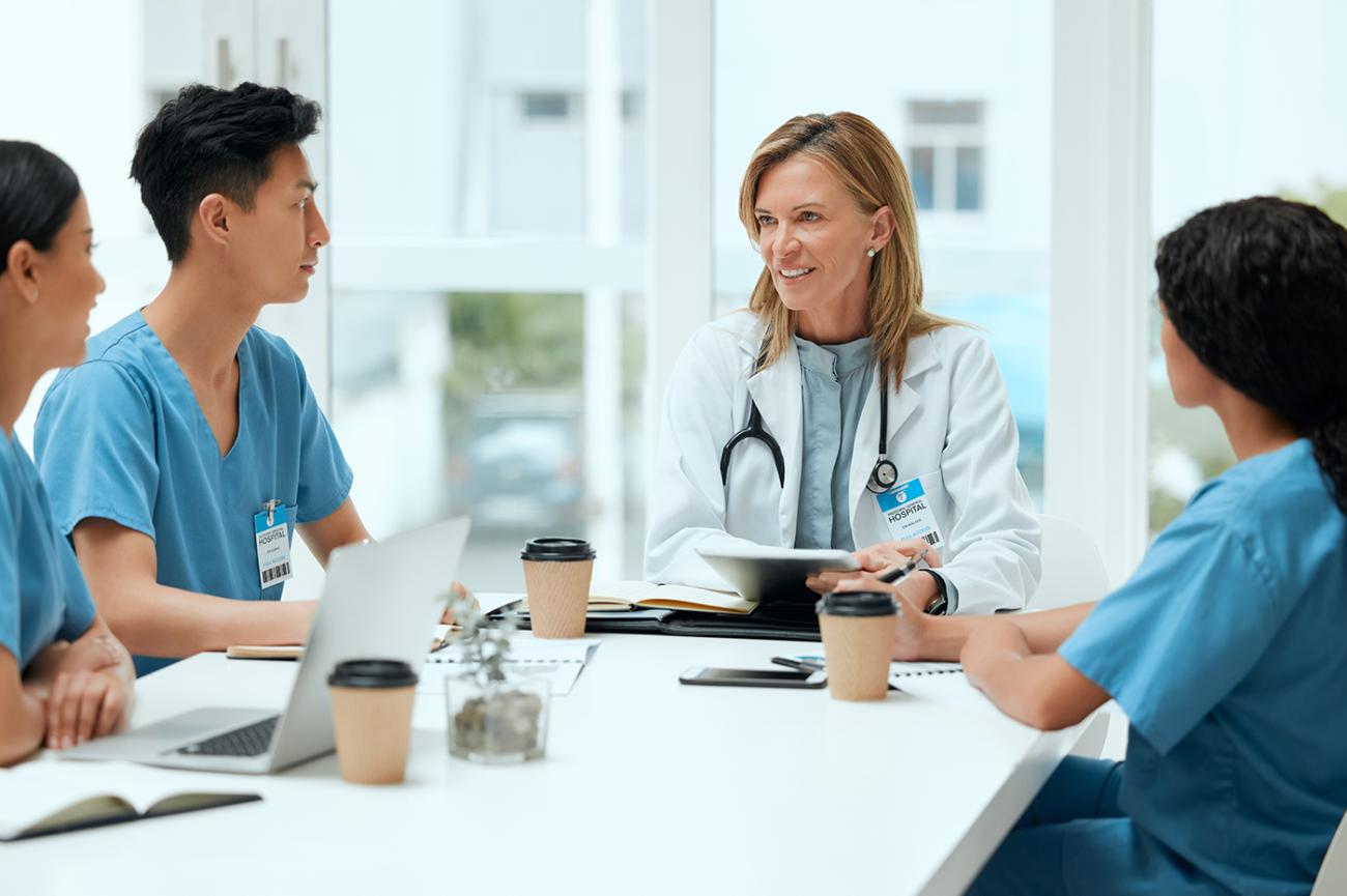 Healthcare Professionals sitting at meeting table discussing