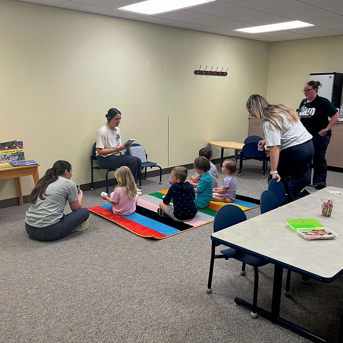 Speech language pathology graduate students read to children in the PALS program.