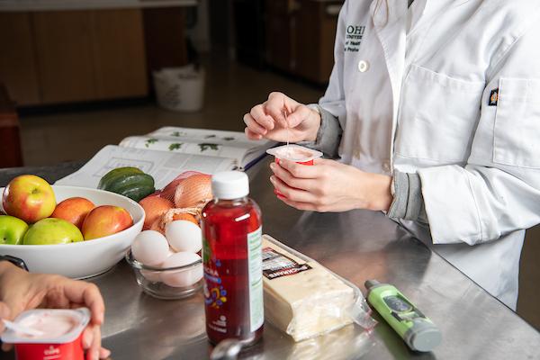 Closeup of a nutrition student working with food