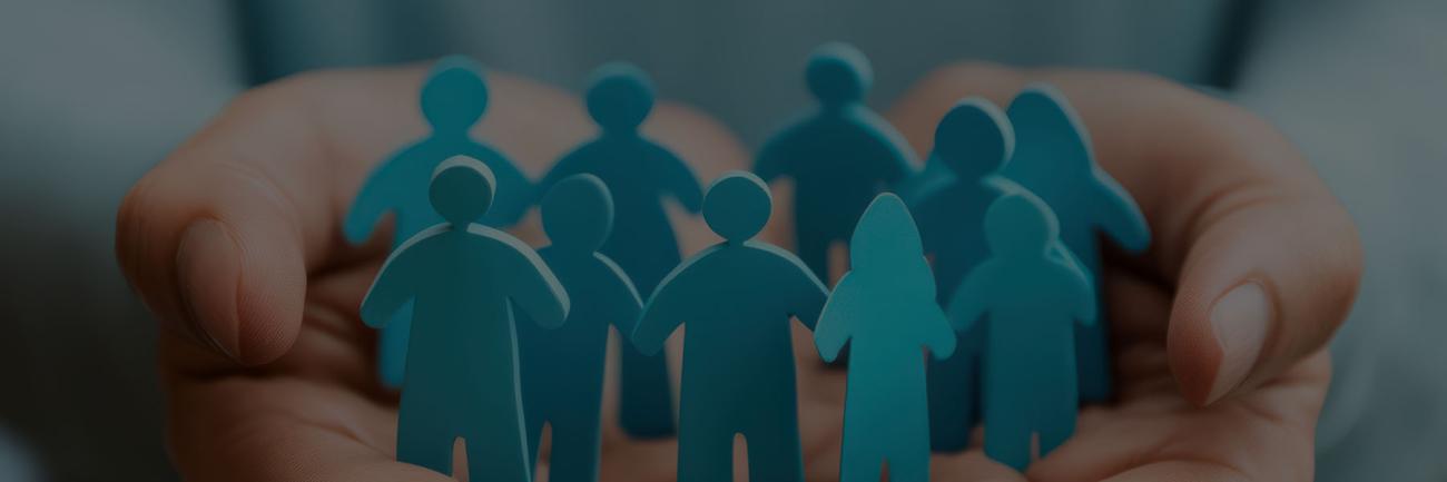 hands holding a circle of cut-out people