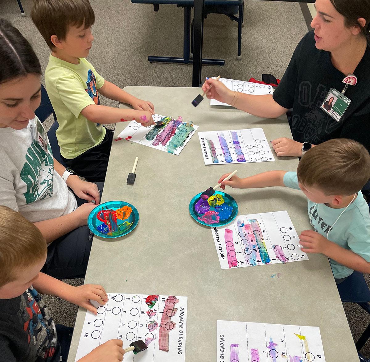 Speech language pathology graduate students do hands-on activities with kids in the PALS program.