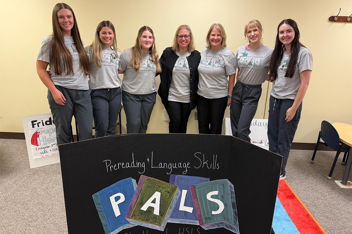 Speech language pathology graduate students and faculty who work in the PALS Program pose for a photo.