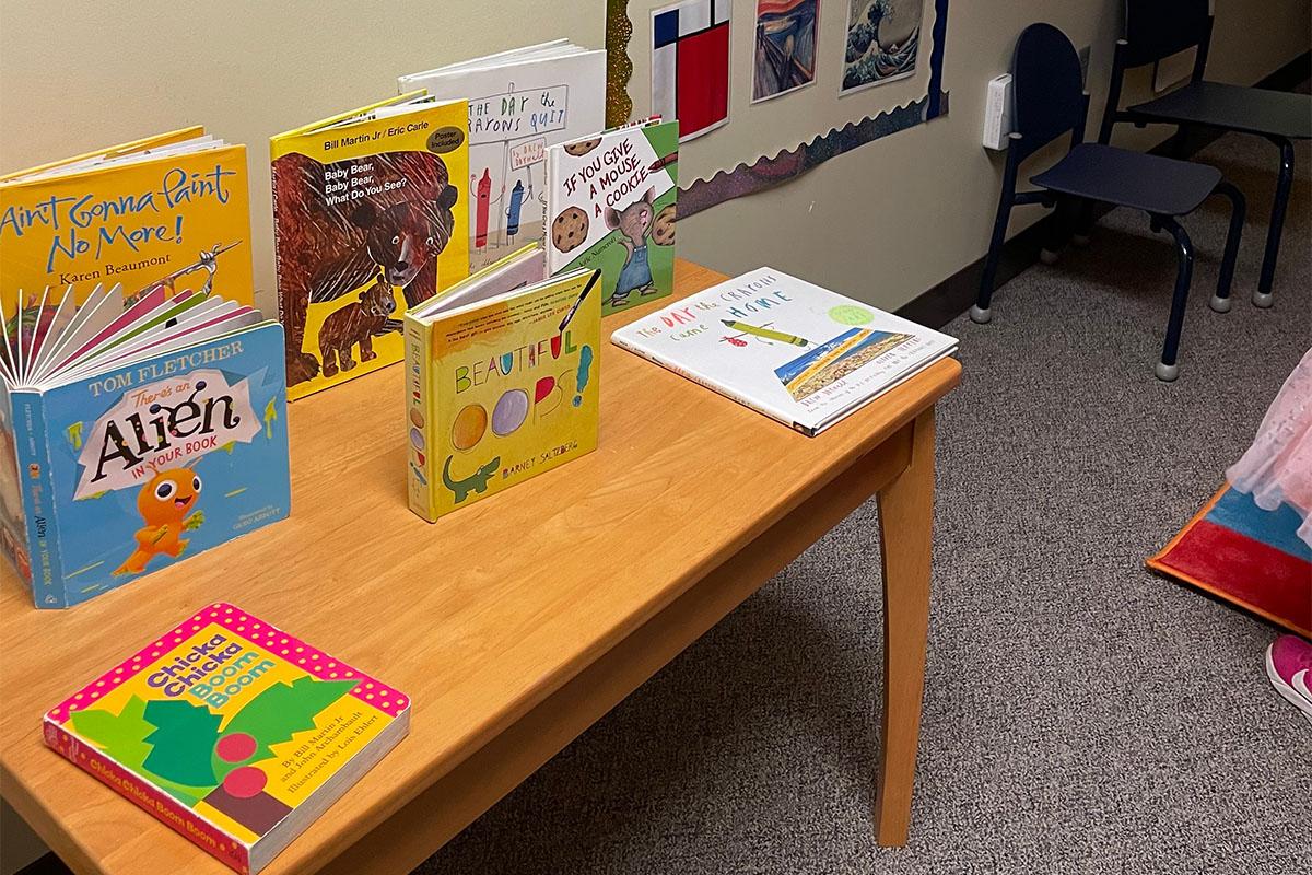 A collection of children's books on a table for the PALS program.
