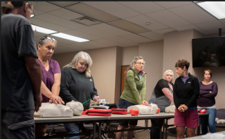 Individuals learning to do CPR