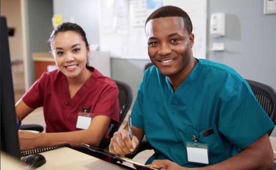 male and female health care workers at computer