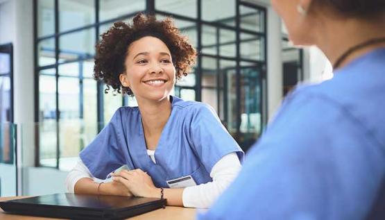 Two MSN PMHNP students sitting at a table between classes