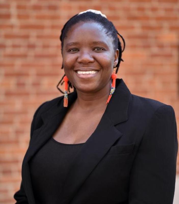 Bose Maposa wearing a black top and a black jacket