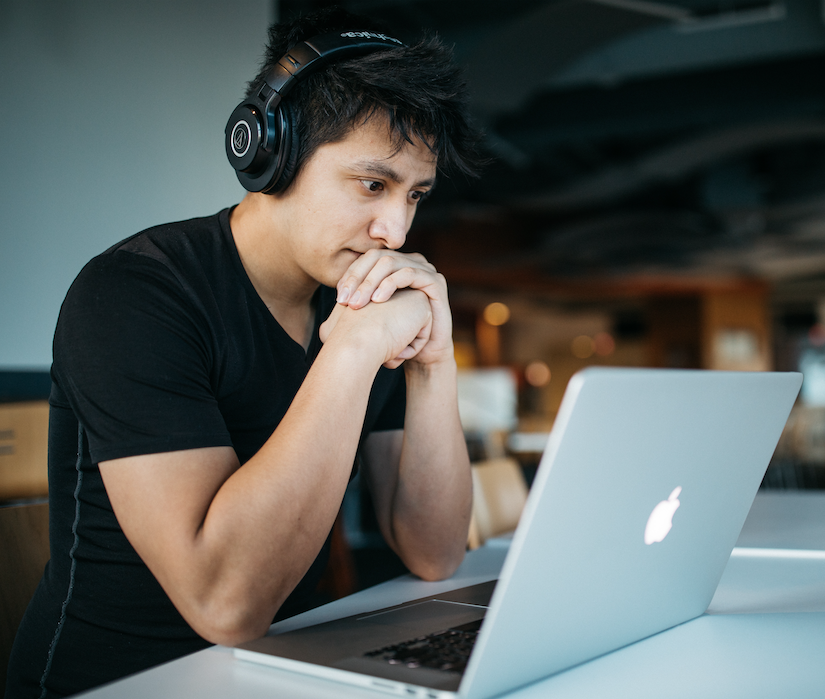 male student studying with headphones